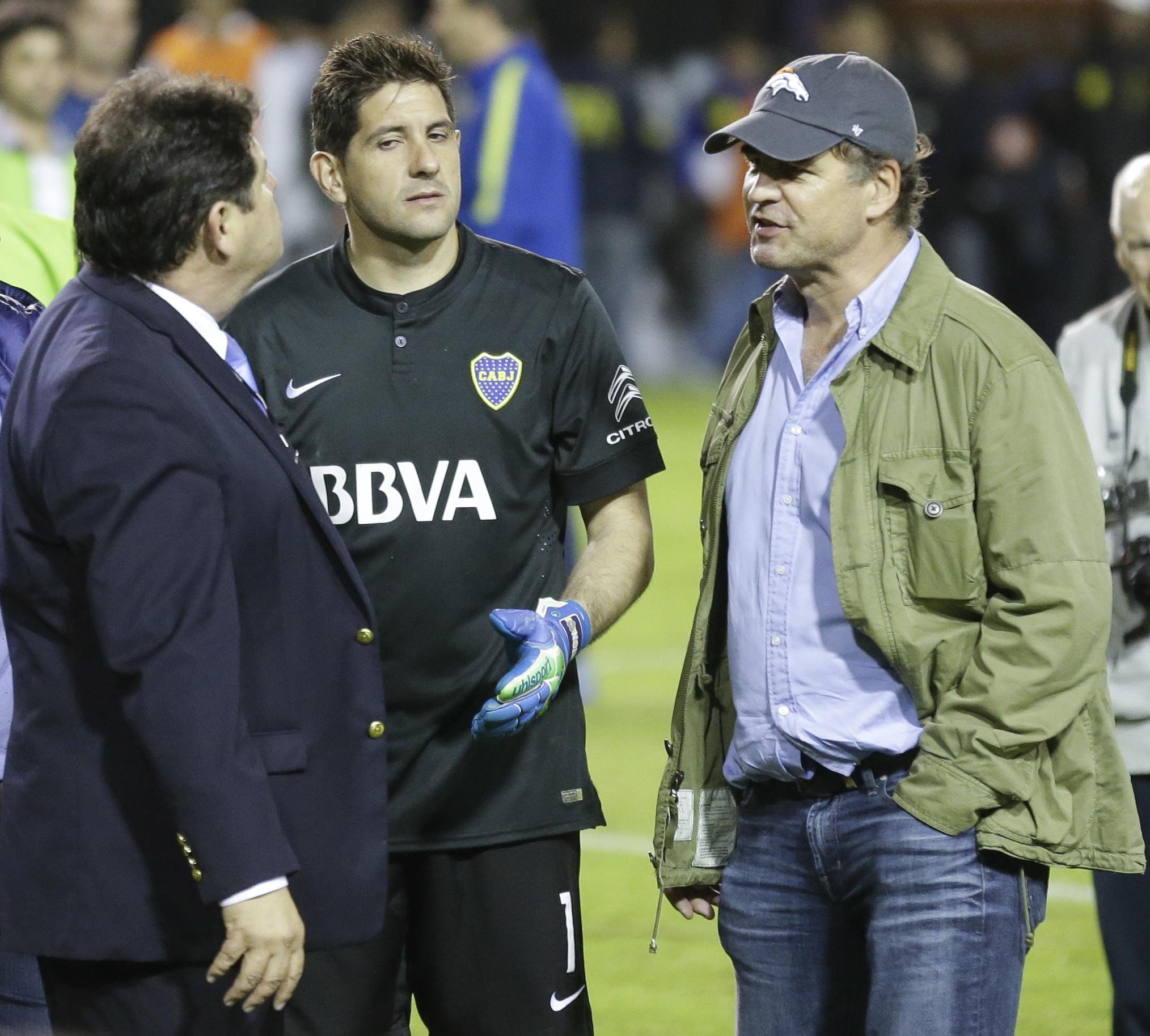 CONMEBOL delegate Roger Bello of Bolivia left talks with Boca Juniors goalkeeper Agustin Orion center and Alejandro Burzaco president of Torneos y Competencias during a Copa Libertadores soccer match