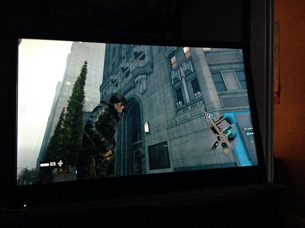 Aiden Pearce checks his pockets outside the proxy for the Chicago Tribune tower in 'Watch Dogs.'