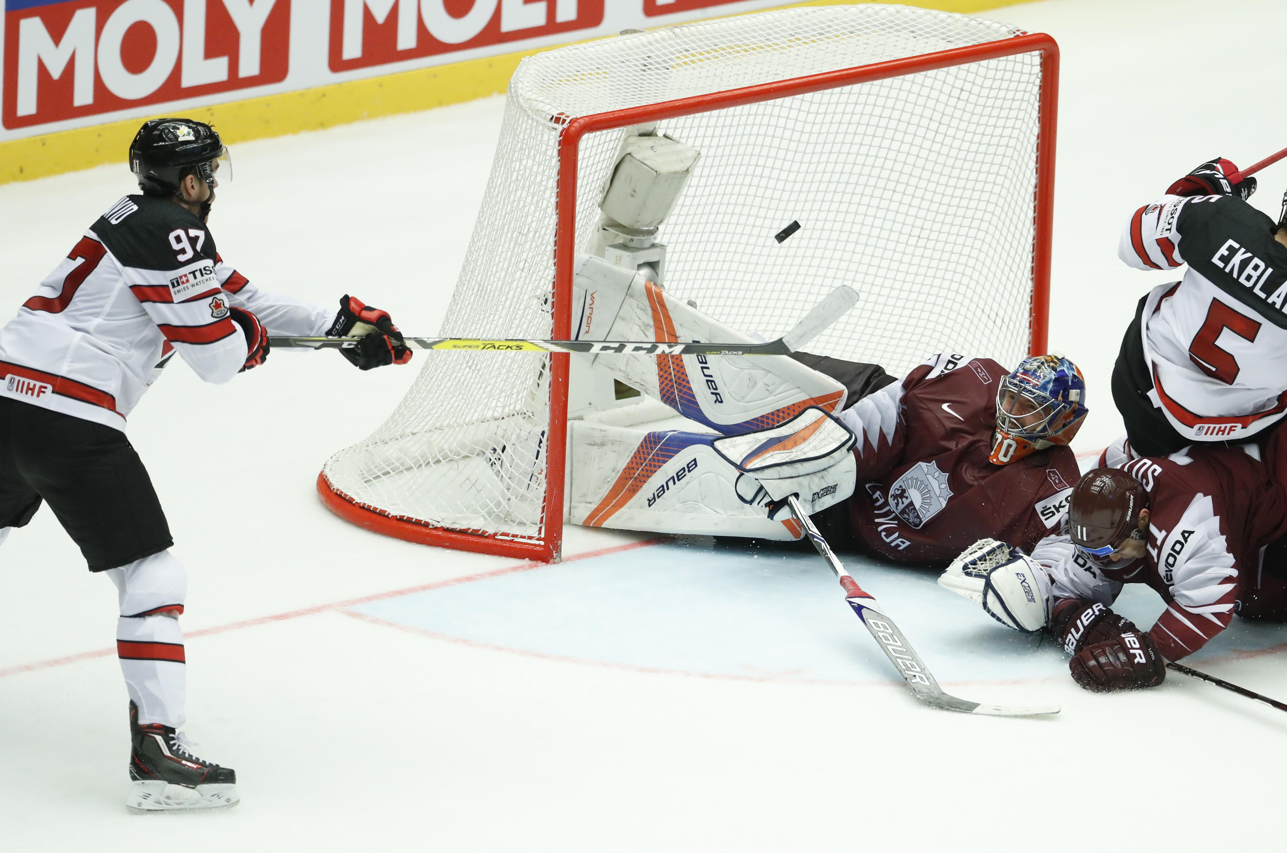 Canada beats Latvia in OT to reach world quarterfinals The Spokesman