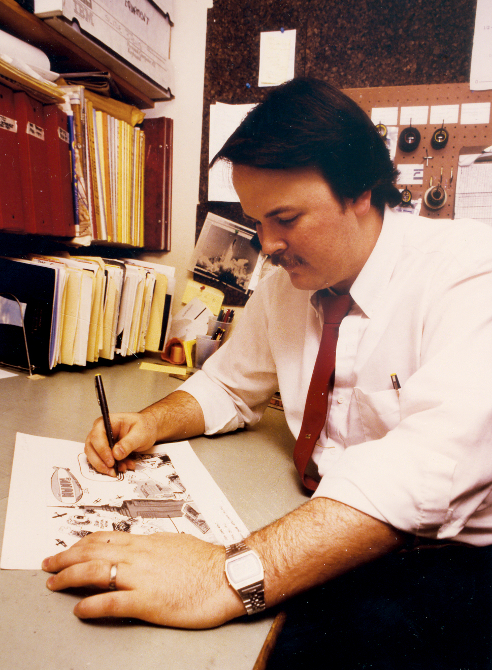 This is me, in 1986, working on a cartoon for two daily newspapers in Athens, Georgia. The morning paper and the afternoon paper had the same staff and worked out of the same newsroom, but had different editorial pages. This gave me twice the opportunities to get a cartoon into print.