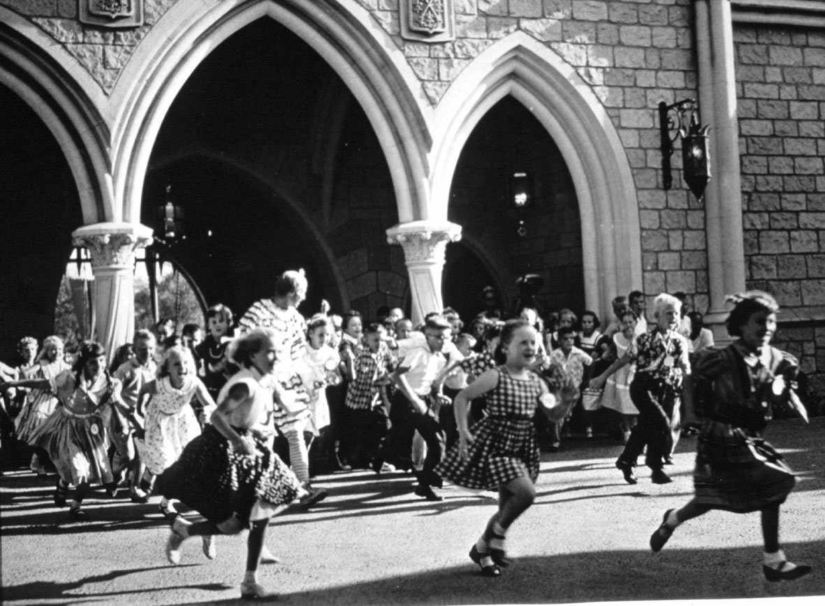 Children race through Cinderella’s Castle to Fantasyland, where they could find a number of attractions open that day, including the Mad Tea Party,Mr. Toad’s Wild Ride and King Arthur’s Carousel.
