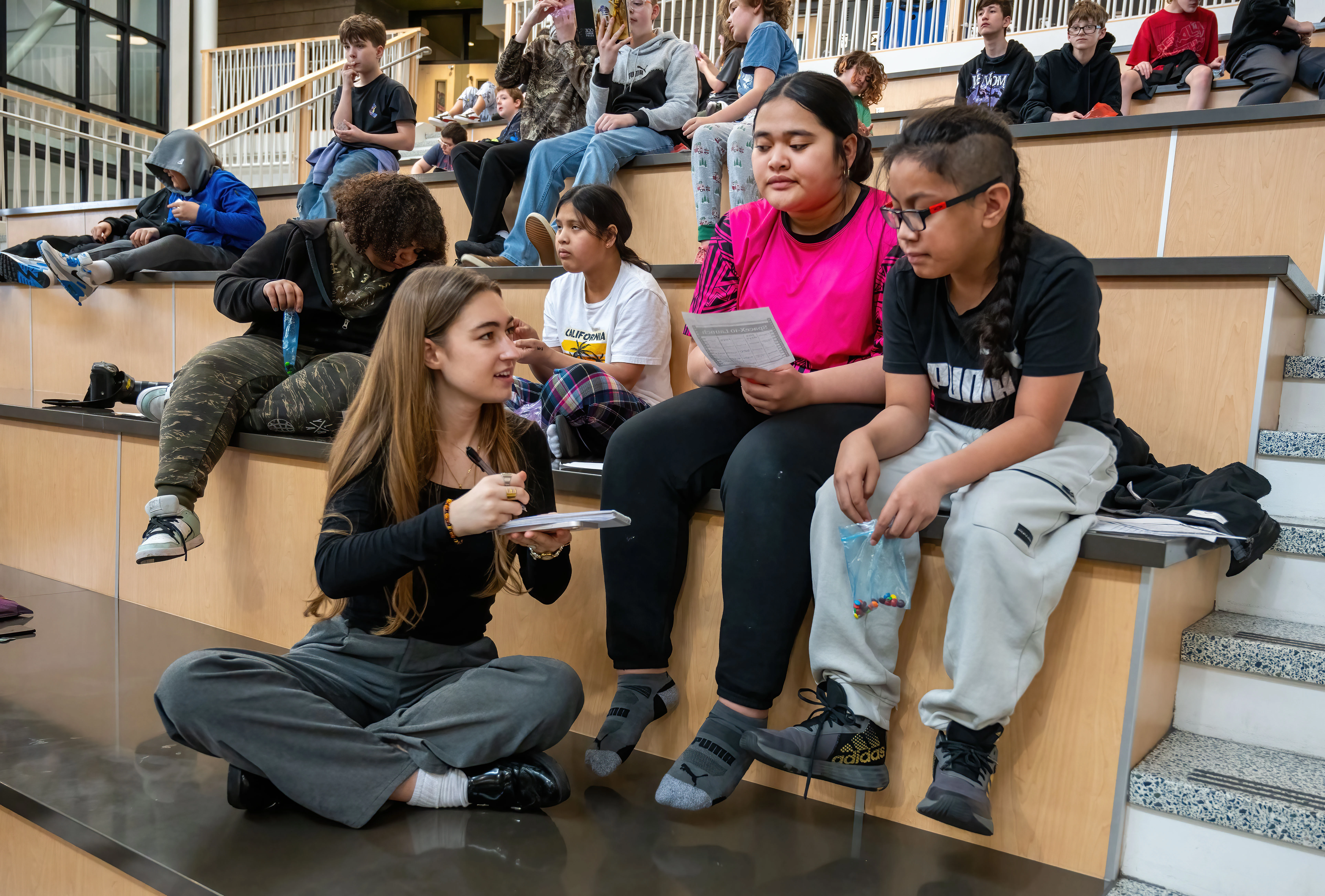 Reporter Elena Perry interviews students at Yasuhara Middle School for a story about local astronaut Anne McClain (Photo: Colin Mulvany)