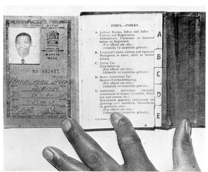 A Black South African resident shows off his government passbook. UC San Diego.